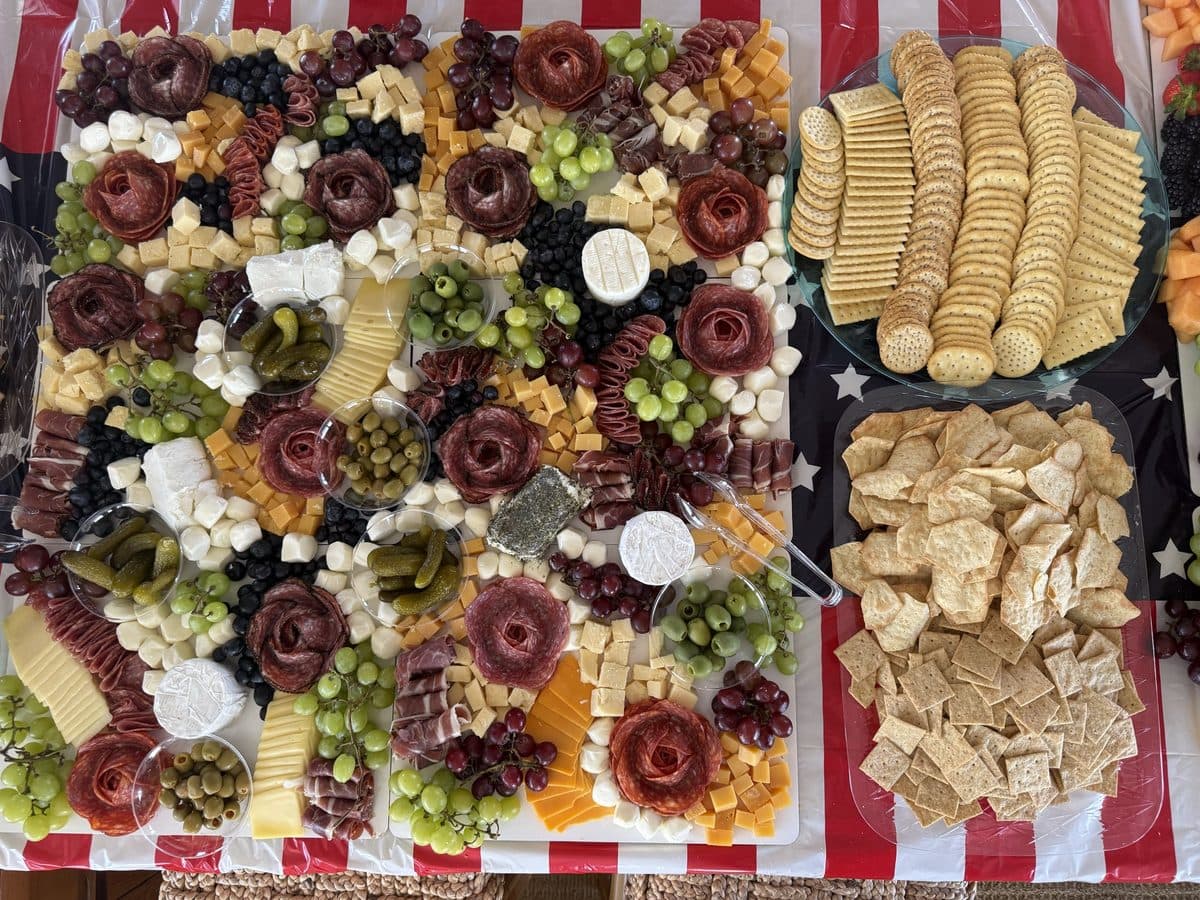 A full grazing table of charcuterie, cheeses, fruit and crackers