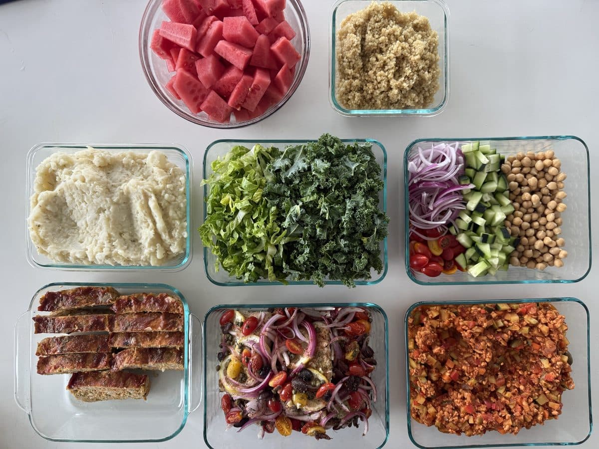 Prepped meals: sliced steak, greens, chickpeas, watermelon and grains